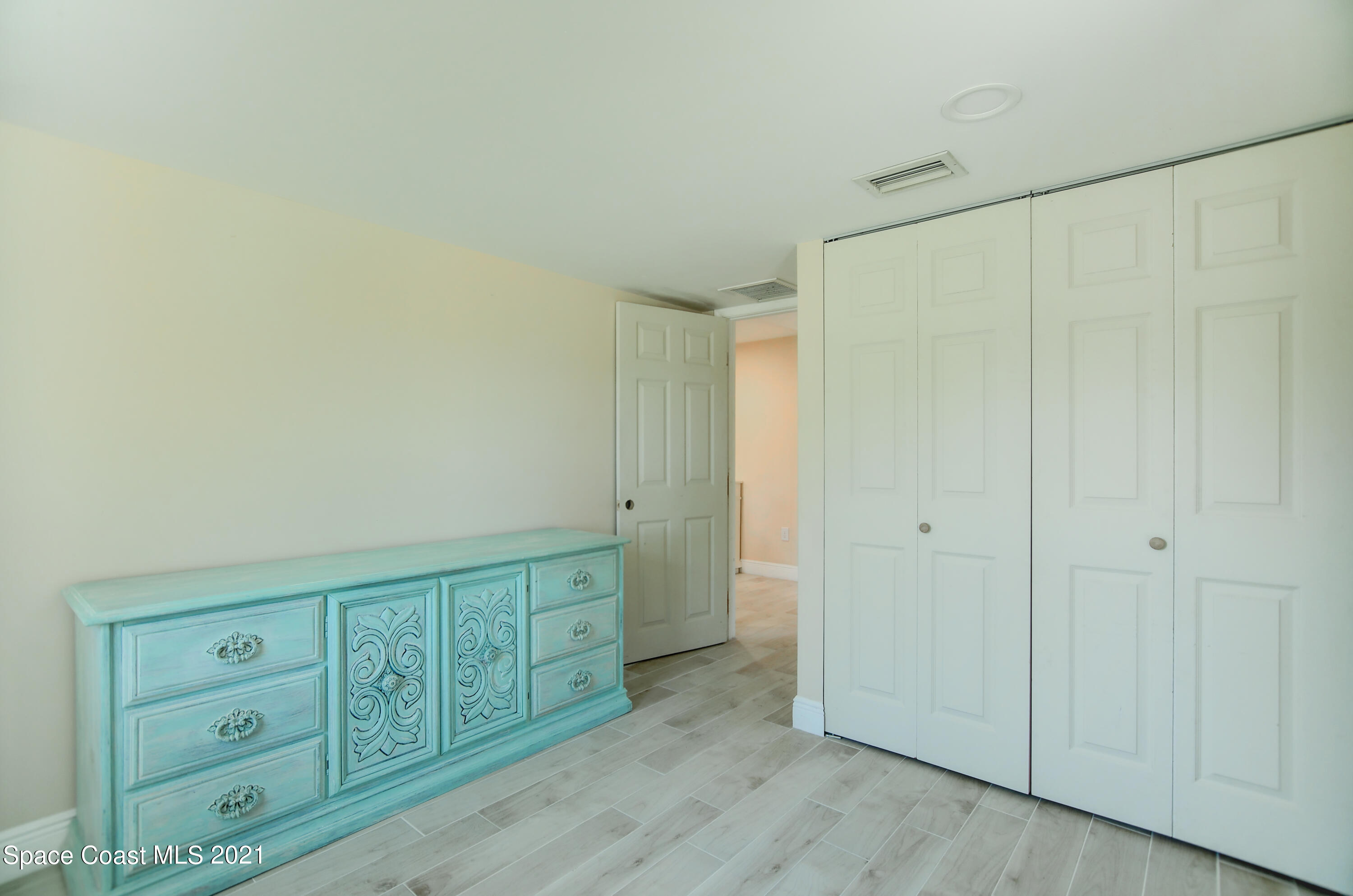 1896 Keewin Avenue Palm Bay, FL 32905 - Photo 18 of 23 a view of a closet with wooden cabinet