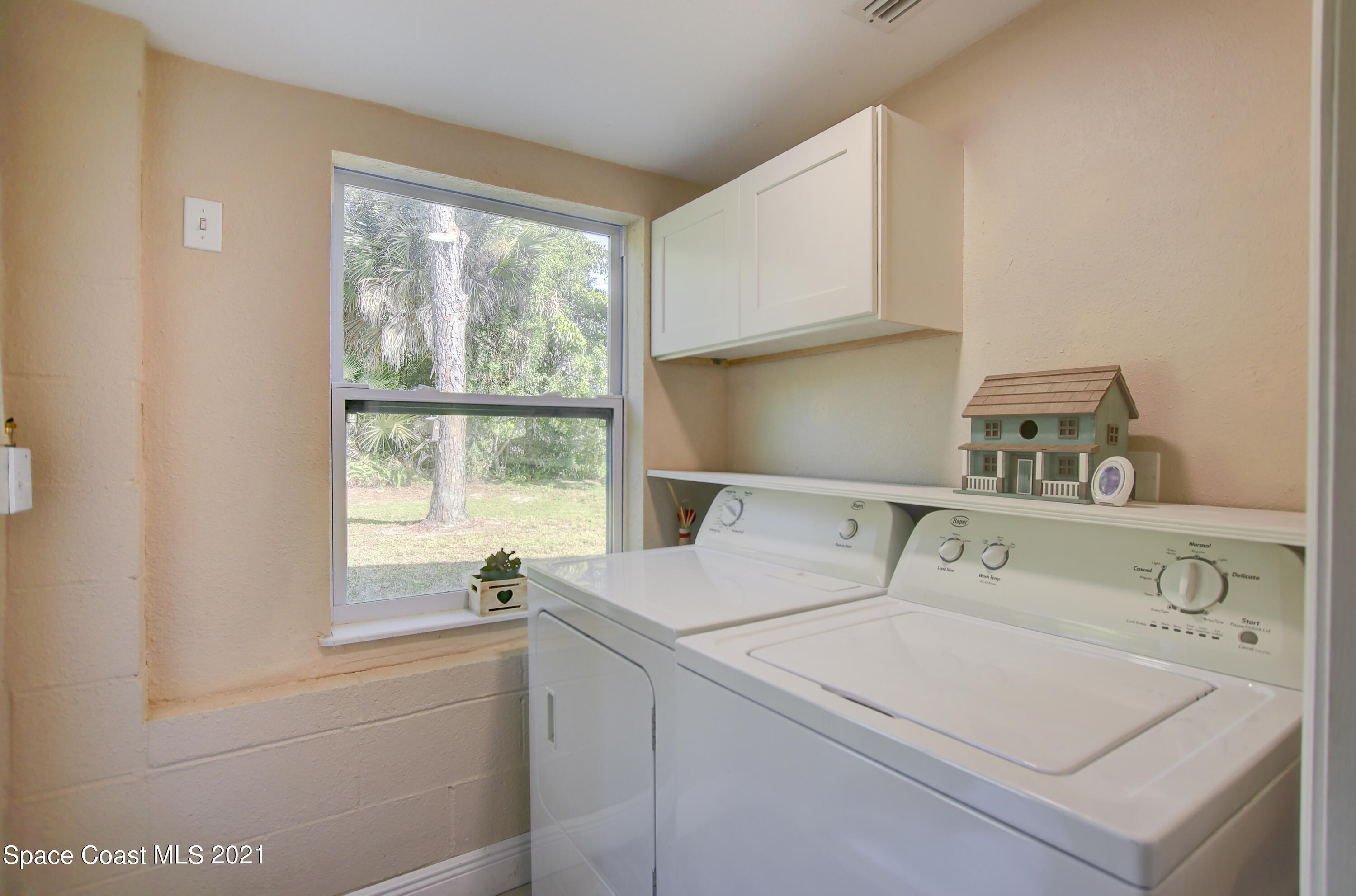 1896 Keewin Avenue Palm Bay, FL 32905 - Photo 20 of 23 a utility room with dryer and window
