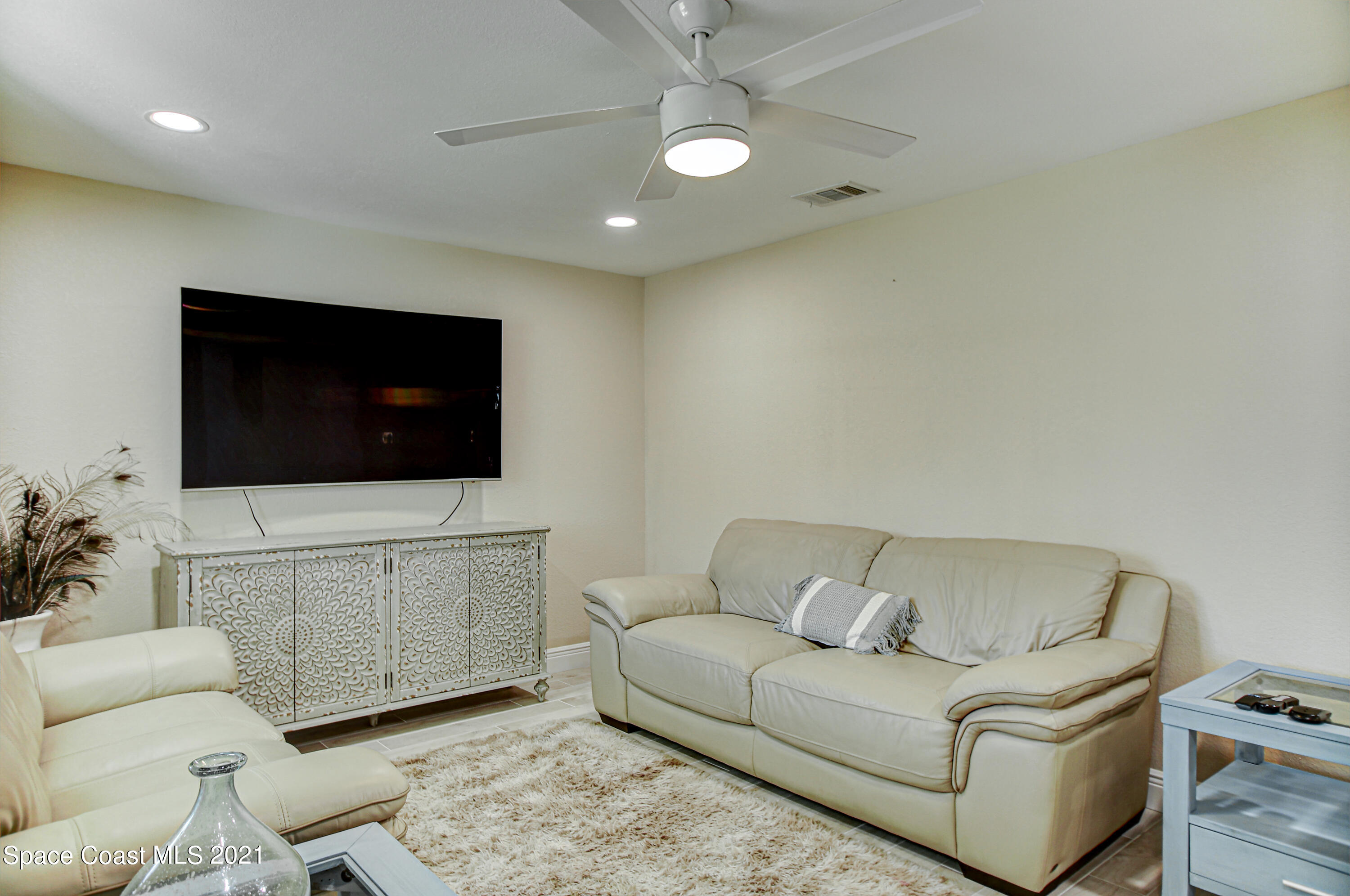 1896 Keewin Avenue Palm Bay, FL 32905 - Photo 6 of 23 a living room with furniture and a flat screen tv