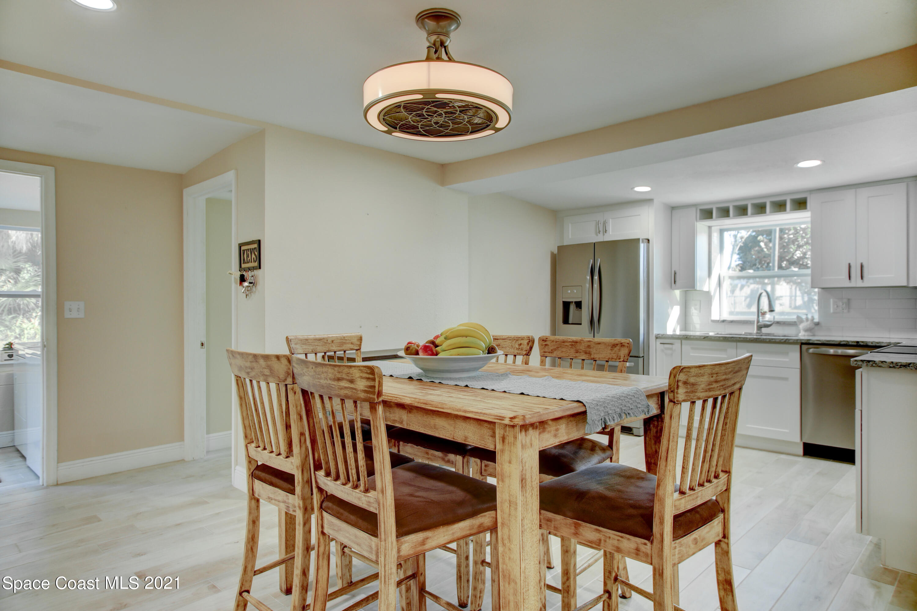 1896 Keewin Avenue Palm Bay, FL 32905 - Photo 8 of 23 a view of a dining room with furniture and a chandelier