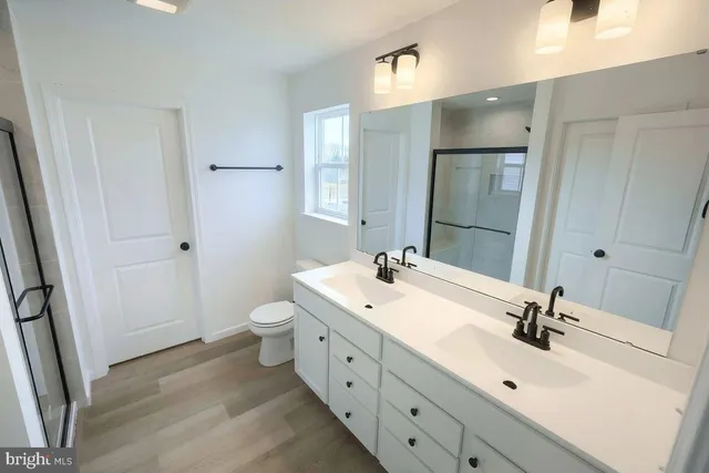 a bathroom with a double vanity sink and mirror