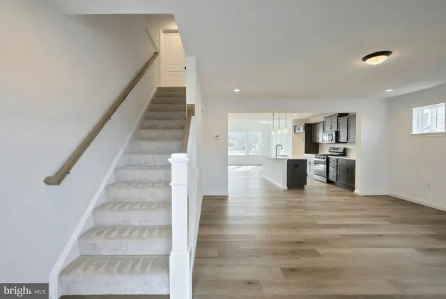 a view of kitchen with wooden floor and electronic appliances