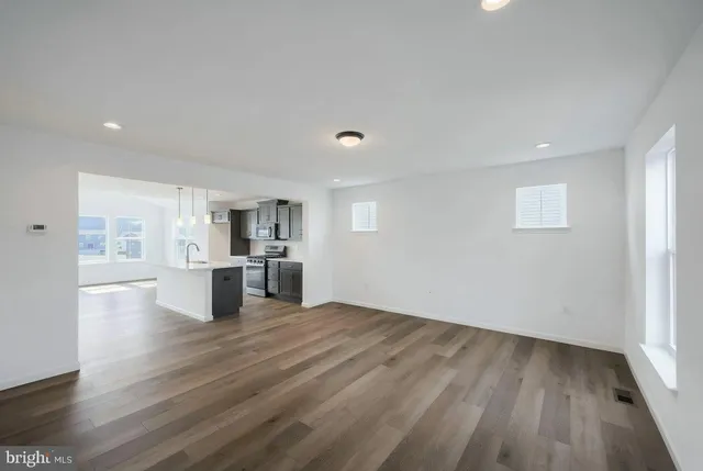 a view of a kitchen with wooden floor