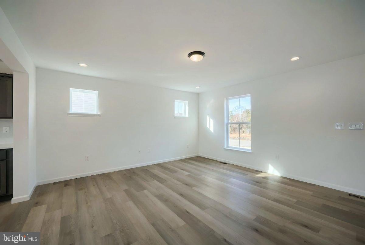 6324 Liam Drive Spring Grove, PA 17362 - Photo 9 of 38 an empty room with wooden floor and windows