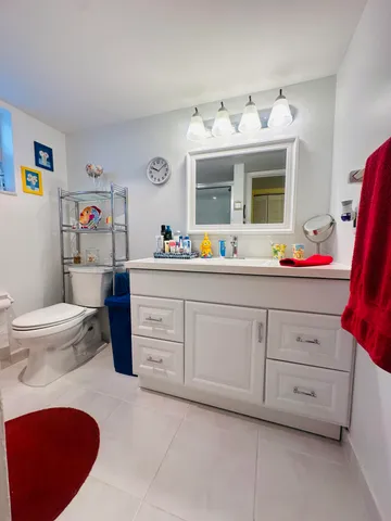 a spacious bathroom with a sink and a mirror