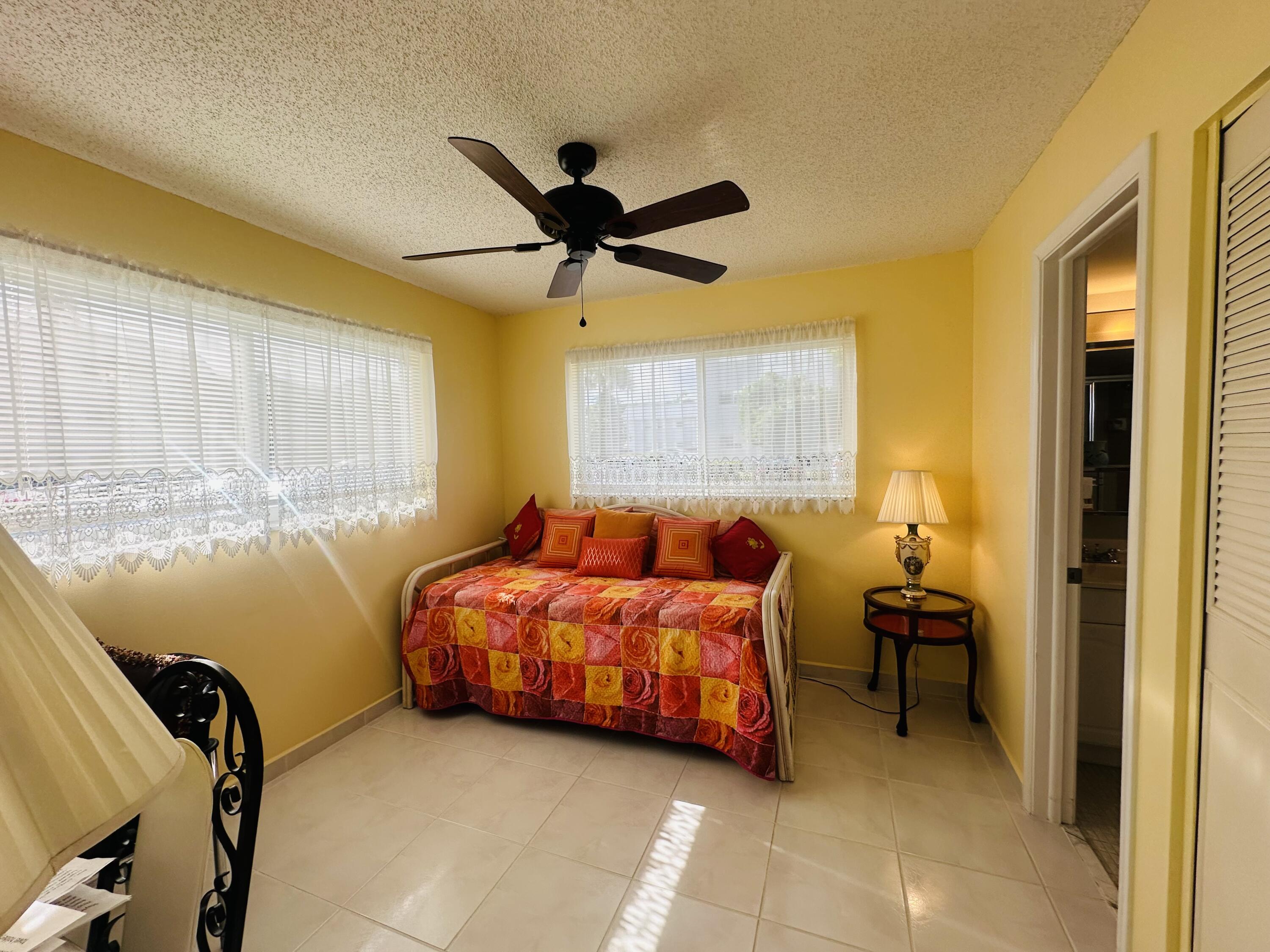 19 Colonial Club Drive, Unit 105 Boynton Beach, FL 33435 - Photo 13 of 53 a bedroom with a bed and a window