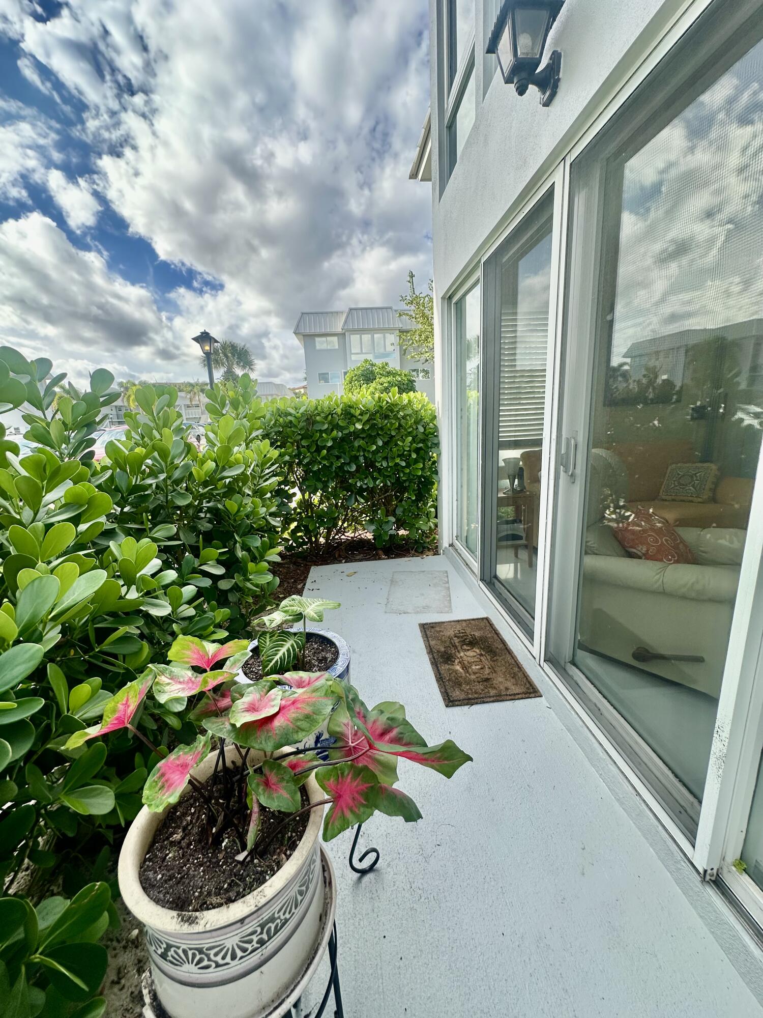 19 Colonial Club Drive, Unit 105 Boynton Beach, FL 33435 - Photo 16 of 53 a flower pot with a potted plant on both side of it