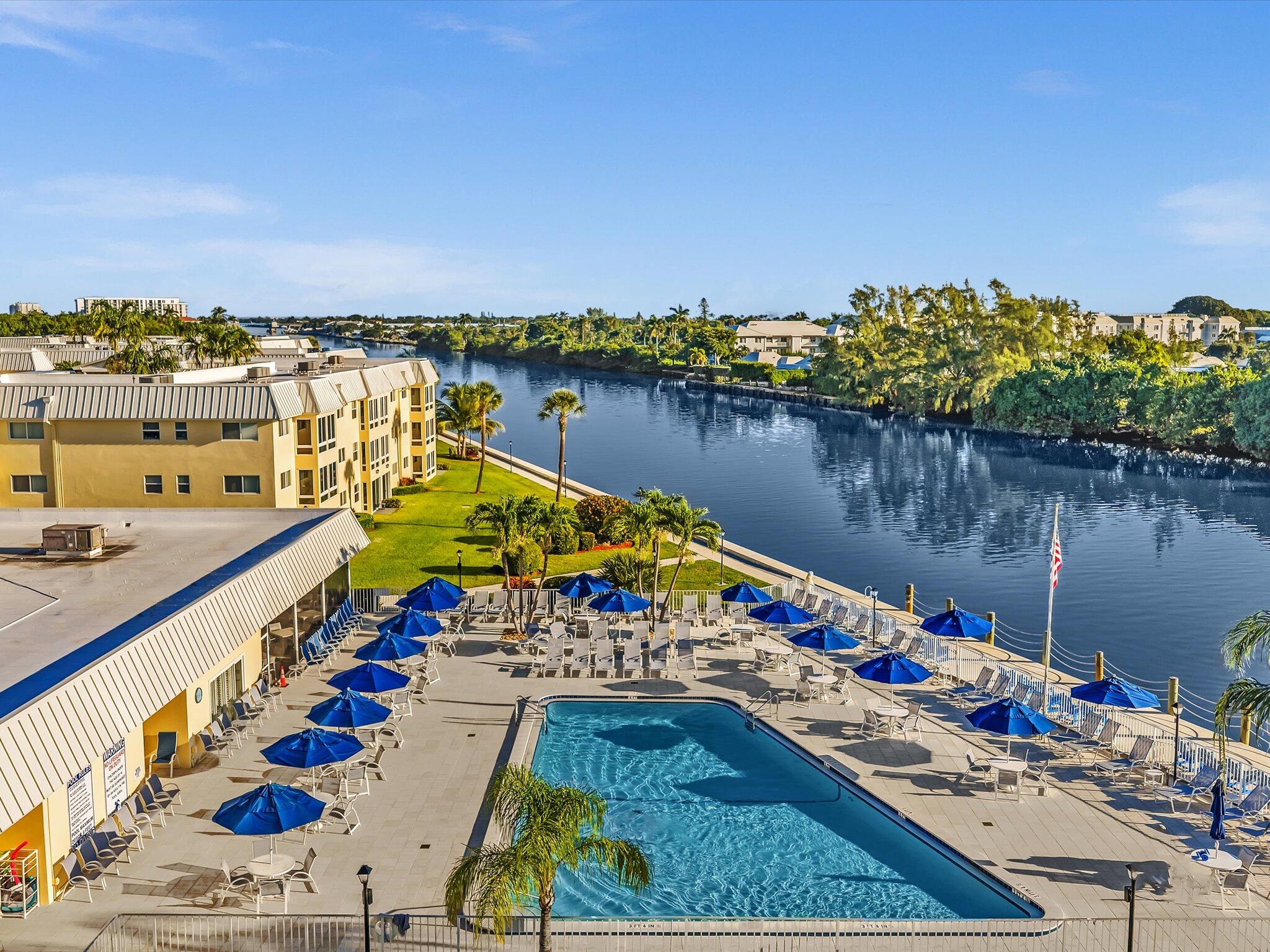 19 Colonial Club Drive, Unit 105 Boynton Beach, FL 33435 - Photo 2 of 53 a view of swimming pool with outdoor seating