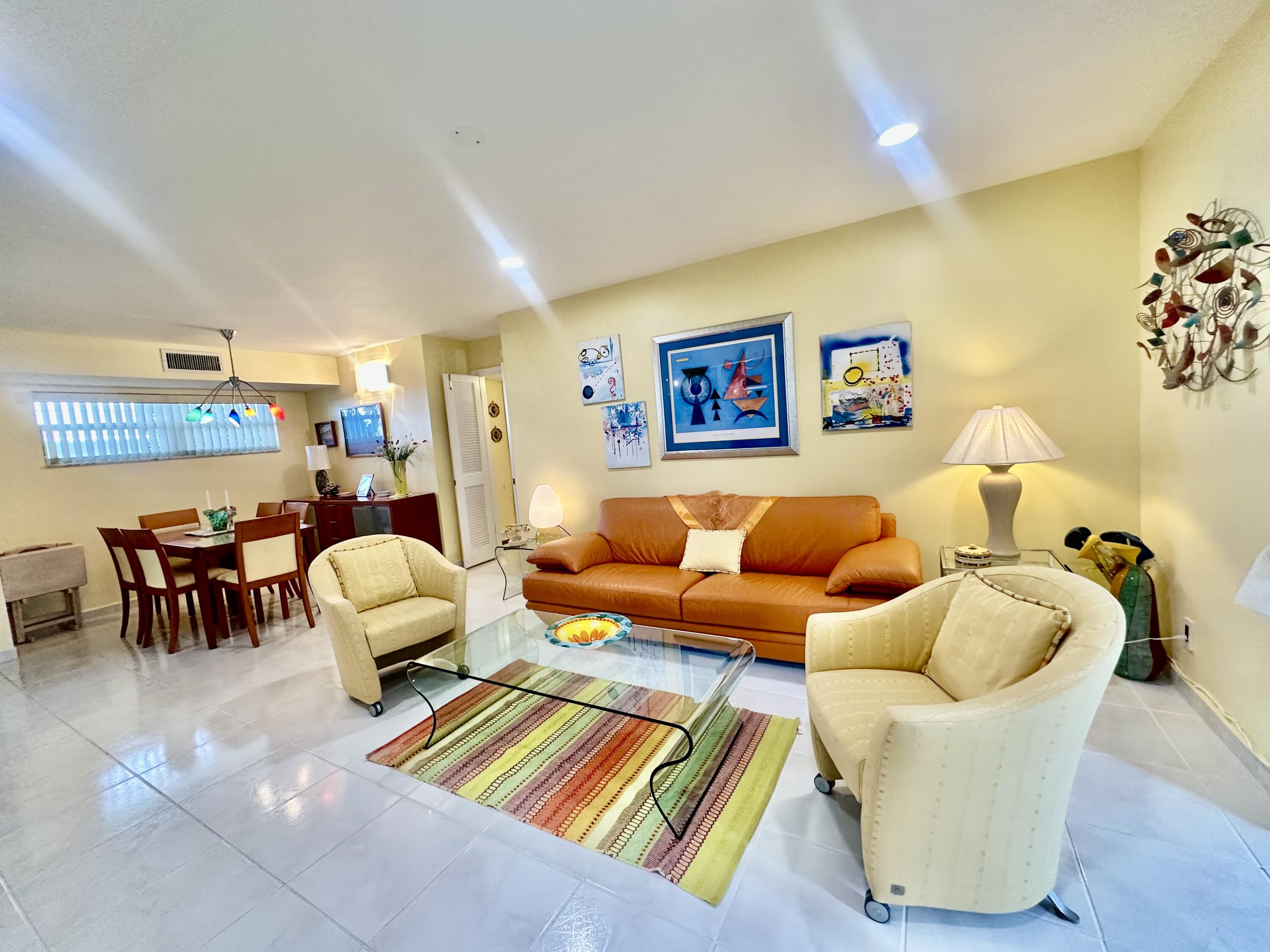 19 Colonial Club Drive, Unit 105 Boynton Beach, FL 33435 - Photo 3 of 53 a living room with furniture and a couch