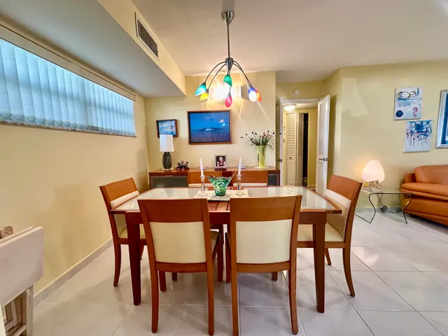 a dining room with a wooden table and chairs