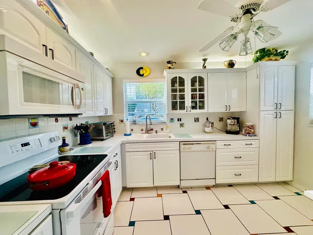 a kitchen with a sink cabinets and window