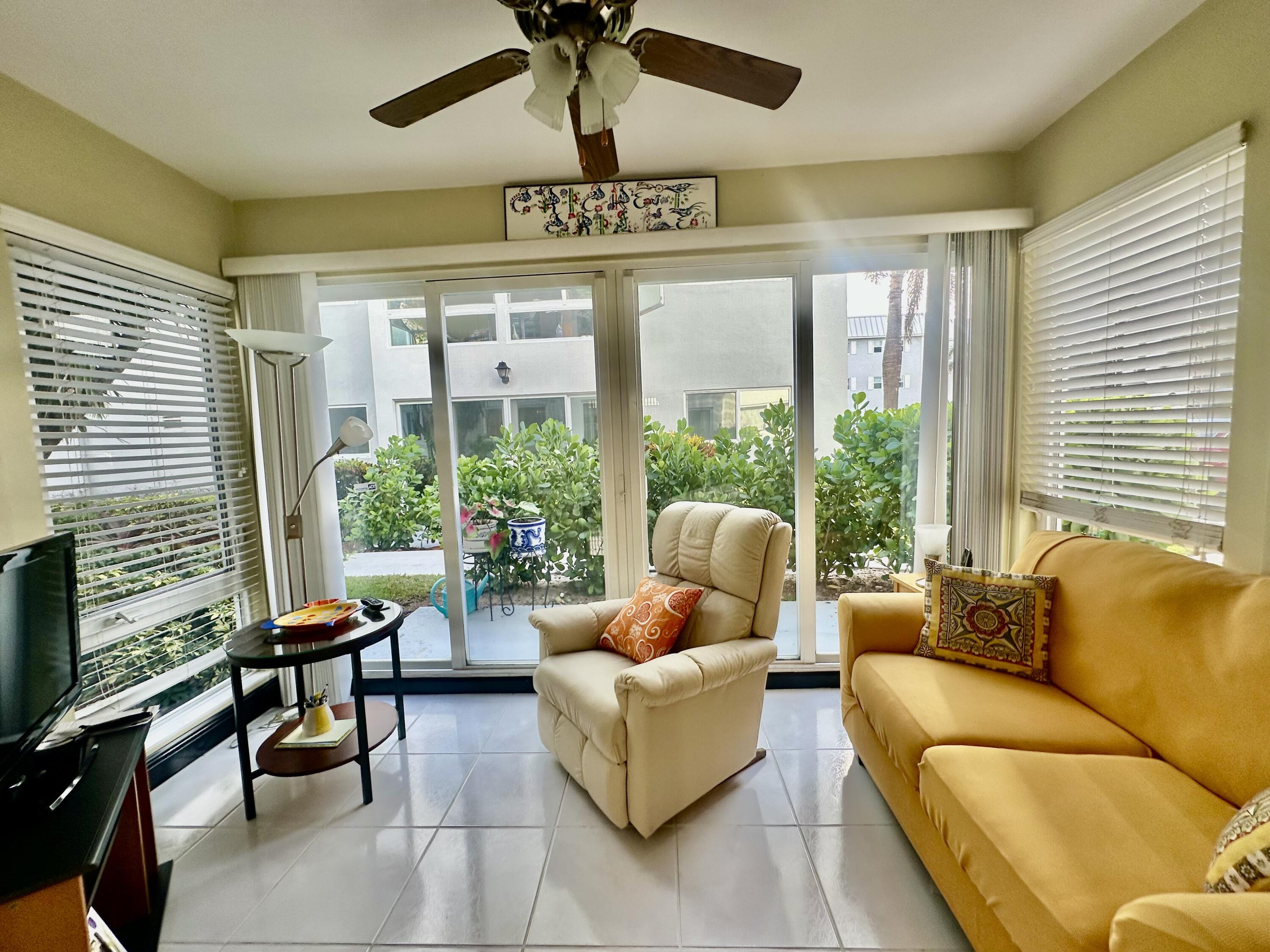 19 Colonial Club Drive, Unit 105 Boynton Beach, FL 33435 - Photo 9 of 53 a living room with furniture and a large window