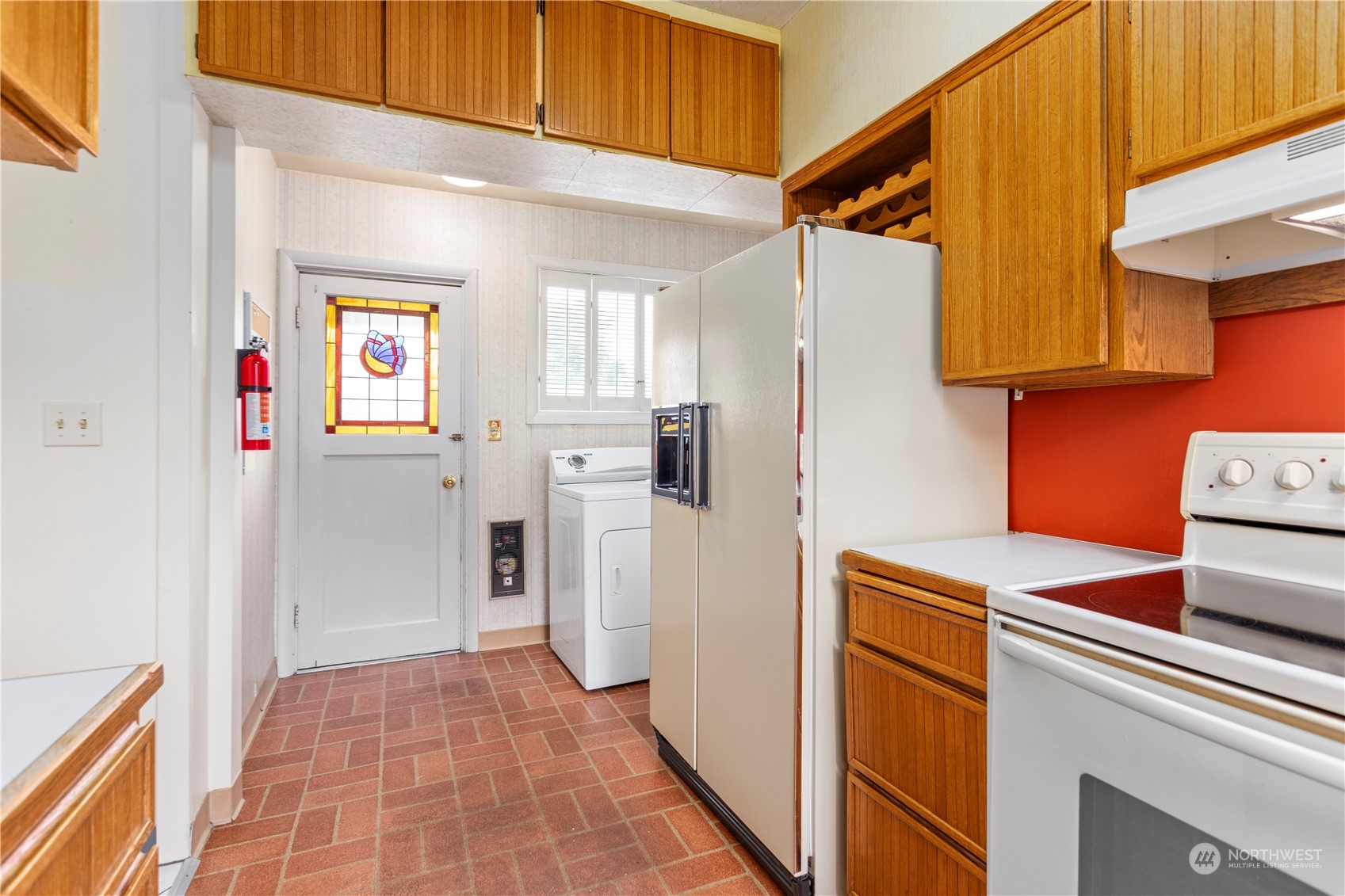 1809 Harris Avenue Bellingham, WA 98225 - Photo 13 of 27 a kitchen with a refrigerator and cabinets
