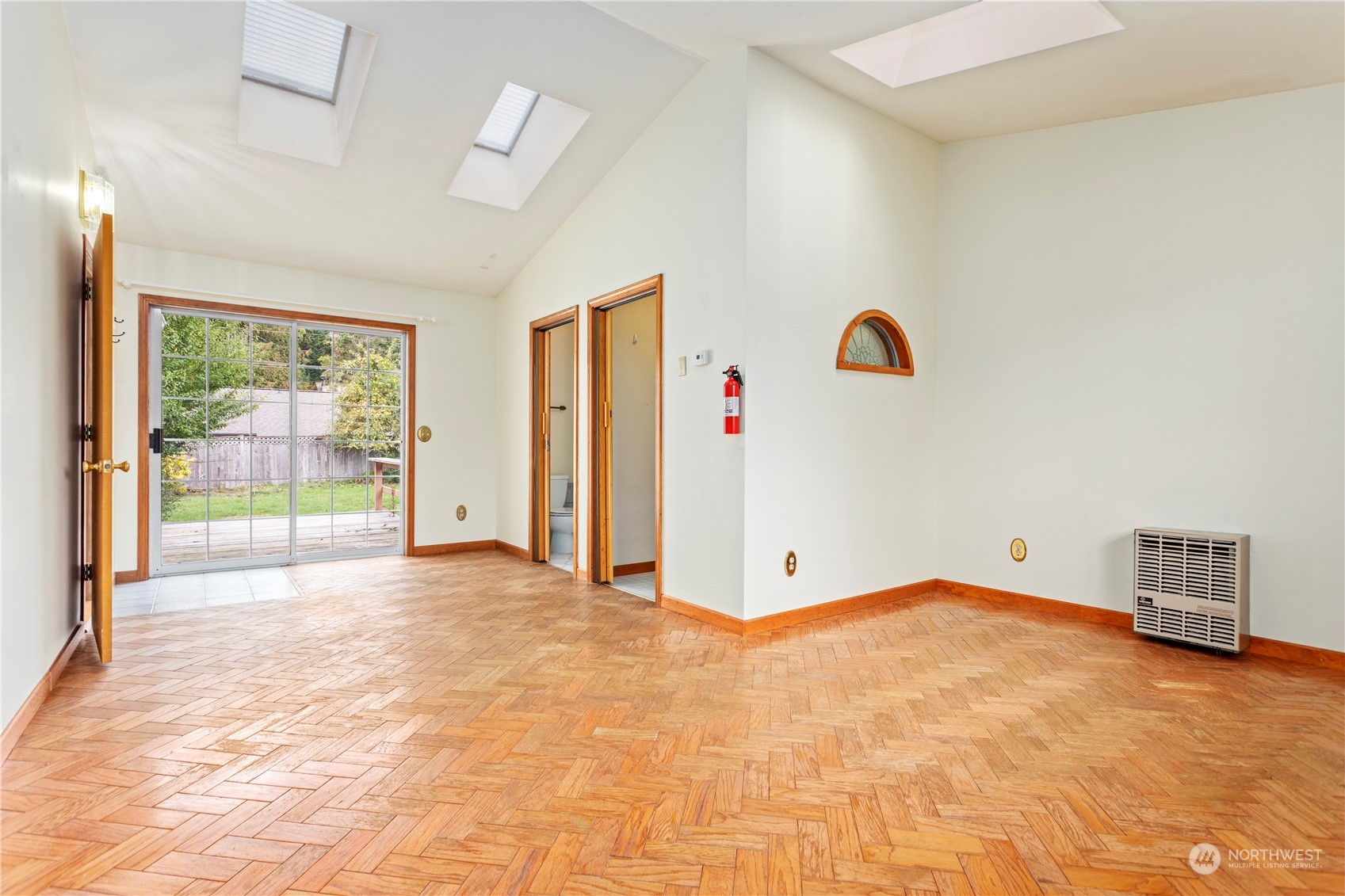 1809 Harris Avenue Bellingham, WA 98225 - Photo 16 of 27 a view of an empty room with wooden floor and windows