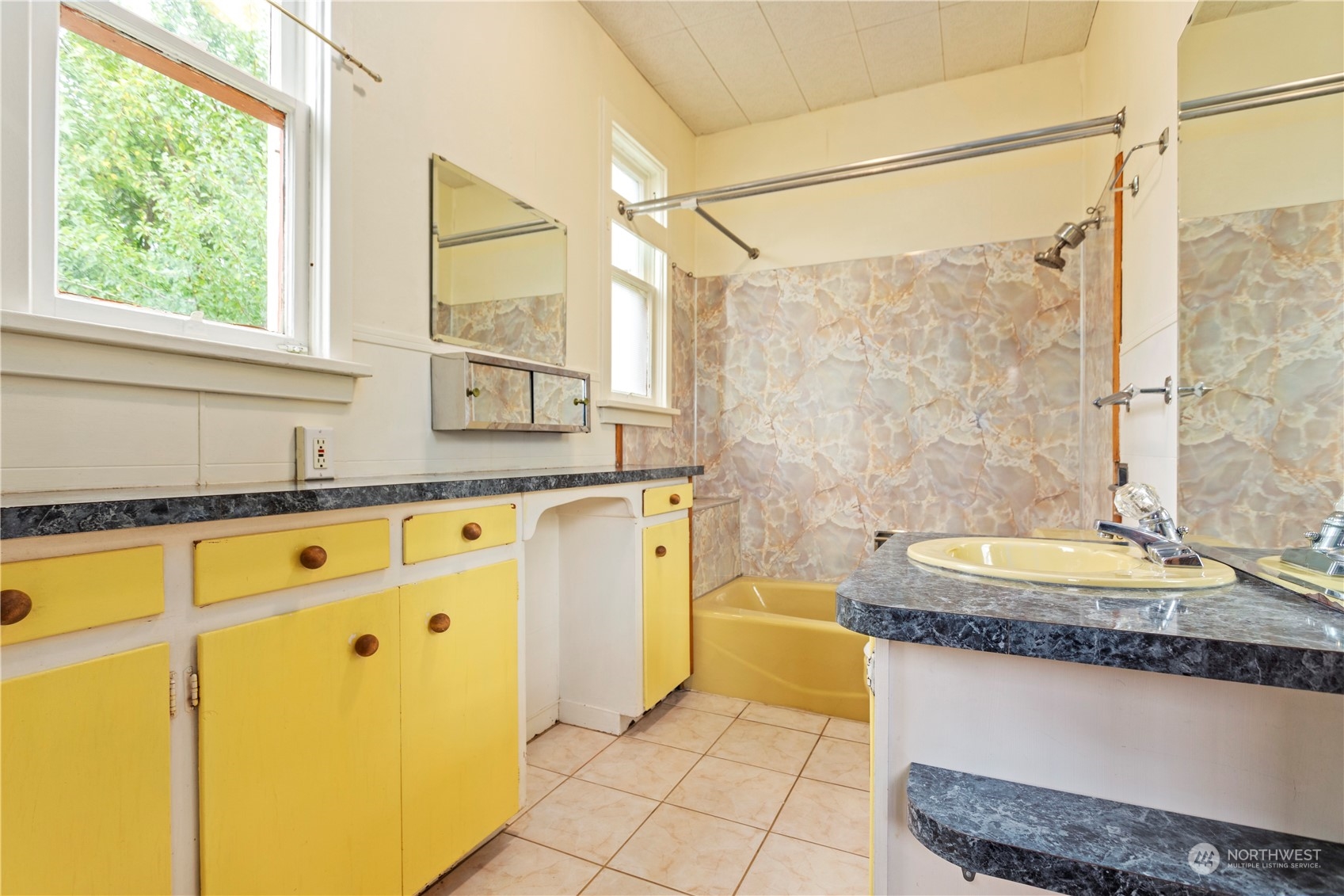 1809 Harris Avenue Bellingham, WA 98225 - Photo 21 of 27 a bathroom with a granite countertop tub sink and mirror