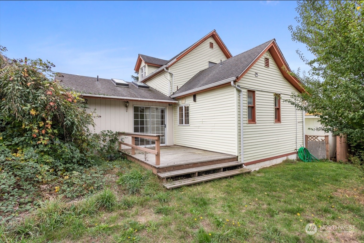 1809 Harris Avenue Bellingham, WA 98225 - Photo 24 of 27 a view of a house with a yard and lawn chairs with wooden fence