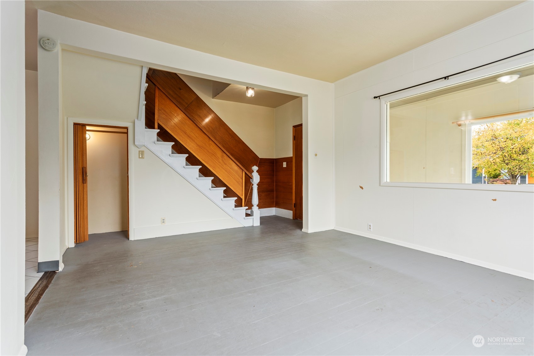 1809 Harris Avenue Bellingham, WA 98225 - Photo 7 of 27 a view of an empty room with wooden floor and a window