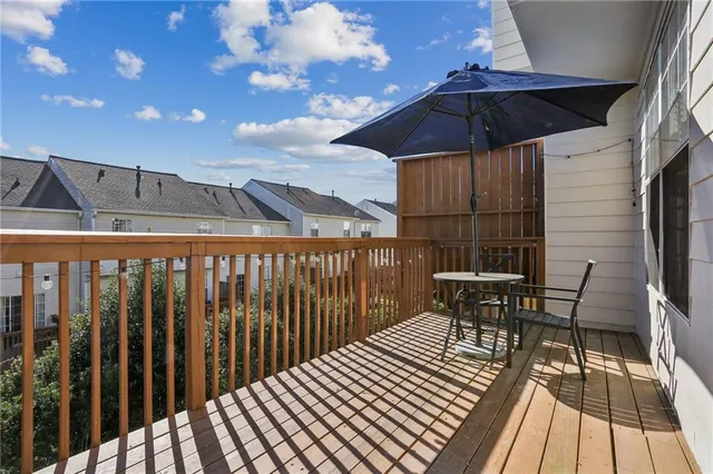 a view of a chairs and table in the balcony