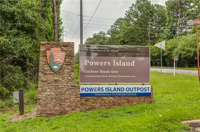a view of outdoor space with a garden and signage
