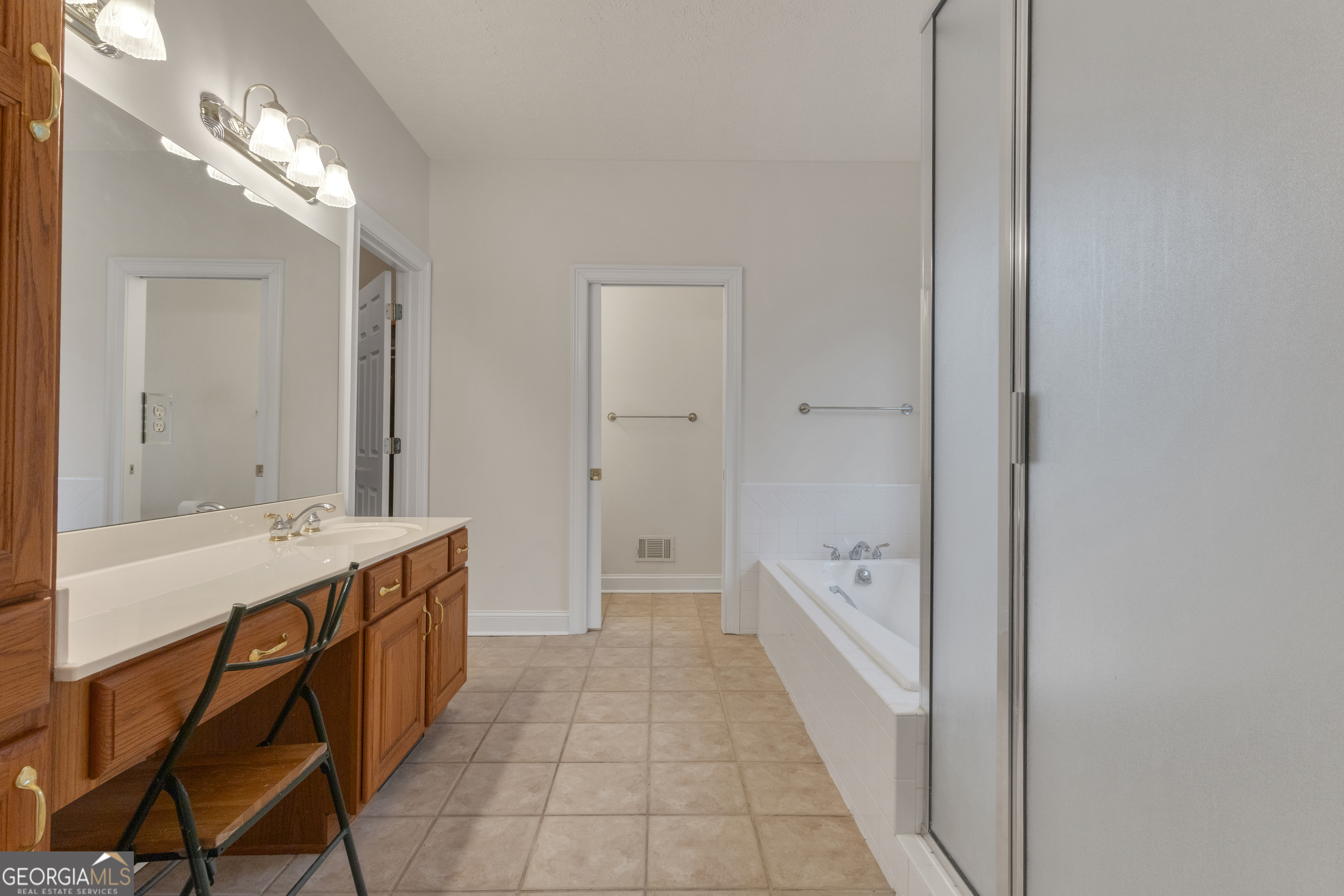 155 Rising Star Road Fayetteville, GA 30215 - Photo 36 of 89 a spacious bathroom with a bathtub and a double vanity sink