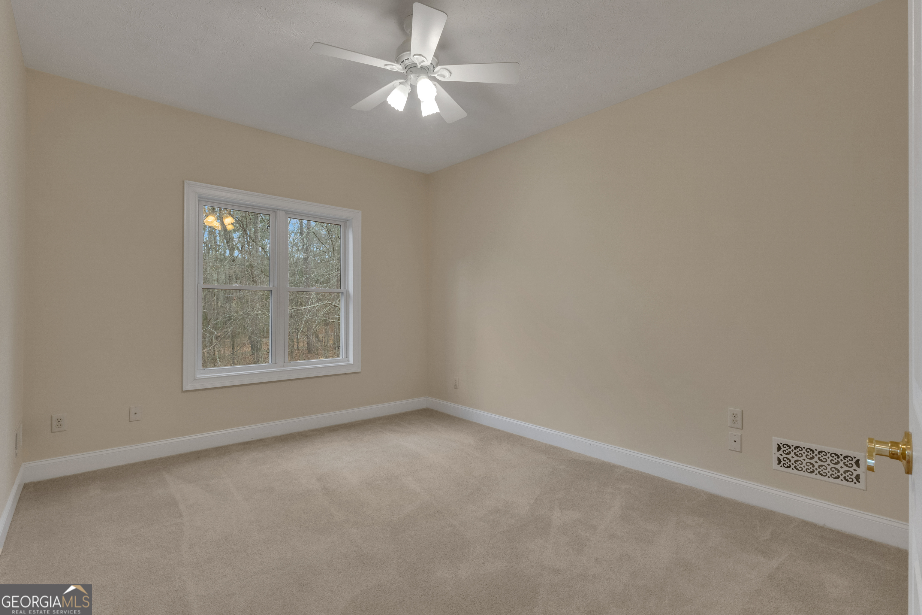155 Rising Star Road Fayetteville, GA 30215 - Photo 46 of 89 an empty room with a window and a fan