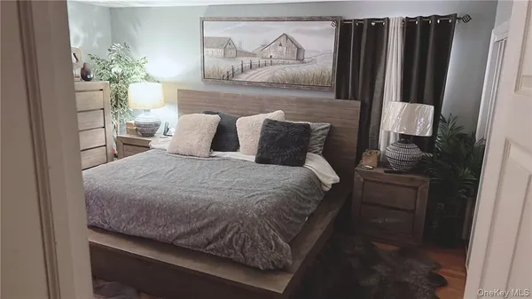 a bedroom with a bed and a potted plant