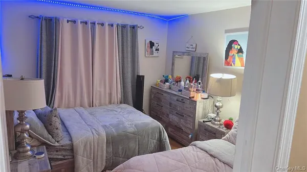a bedroom with two beds and a cabinet