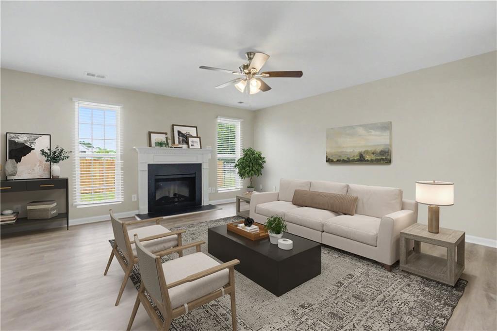 375 Walton View Fairburn, GA 30213 - Photo 10 of 38 a living room with furniture and a fireplace