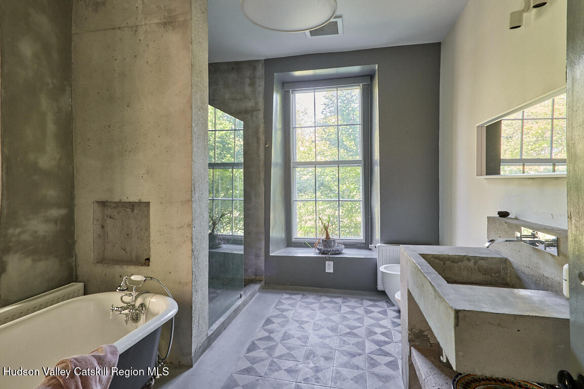 1883 Highway 213 Rifton, NY 12471 - Photo 17 of 46 a spacious bathroom with a tub sink and mirror