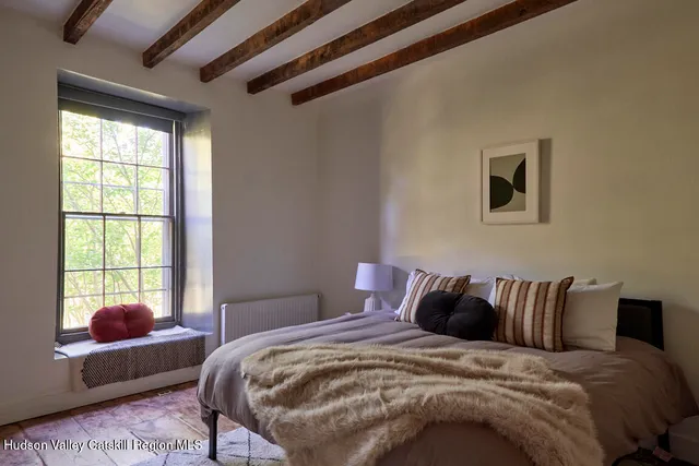 a bedroom with a bed and a window