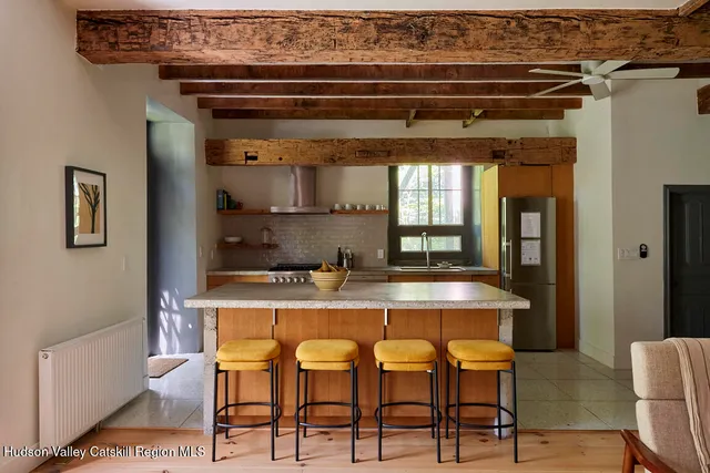 a dining table with chairs and window