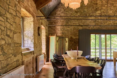 a view of a dining room with furniture and windows