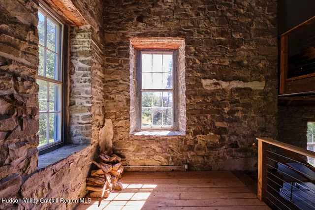 a backyard of a house with barbeque oven and outdoor seating