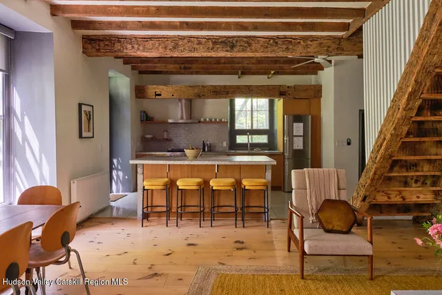 a dining room with furniture and wooden floor