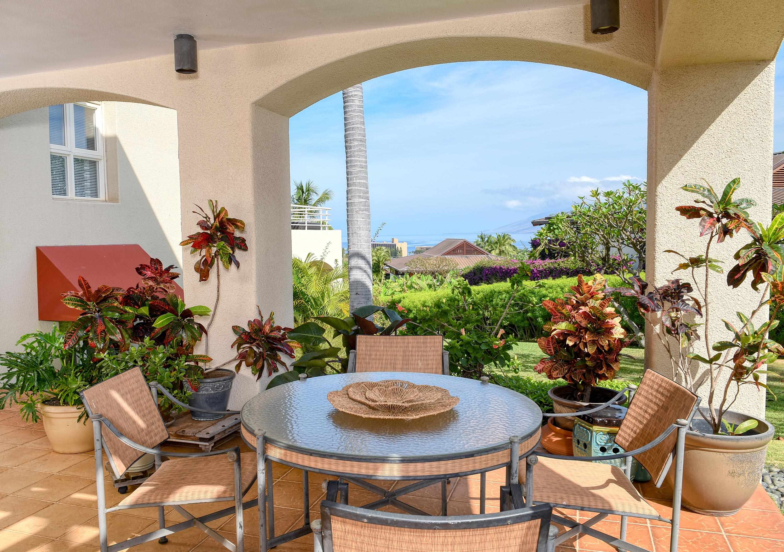 3150 Wailea Alanui Drive, Unit 3807 Kihei, HI 96753 - Photo 1 of 34 a table and chairs in a patio