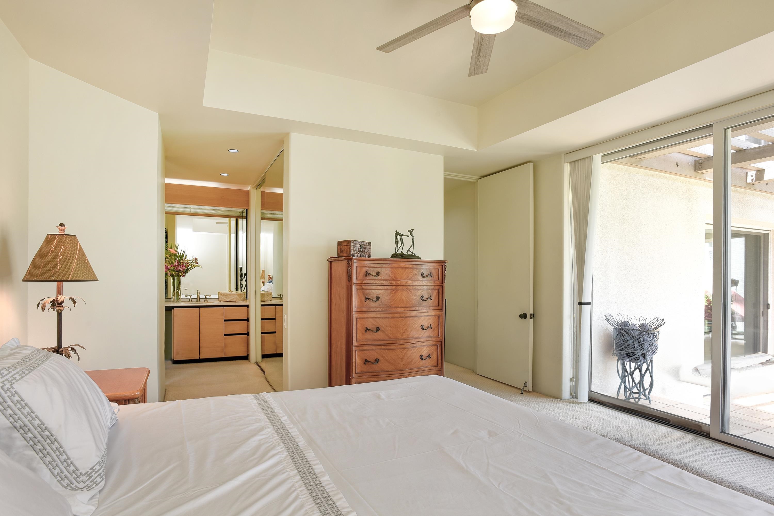 3150 Wailea Alanui Drive, Unit 3807 Kihei, HI 96753 - Photo 15 of 34 a bedroom with a bed and a chandelier
