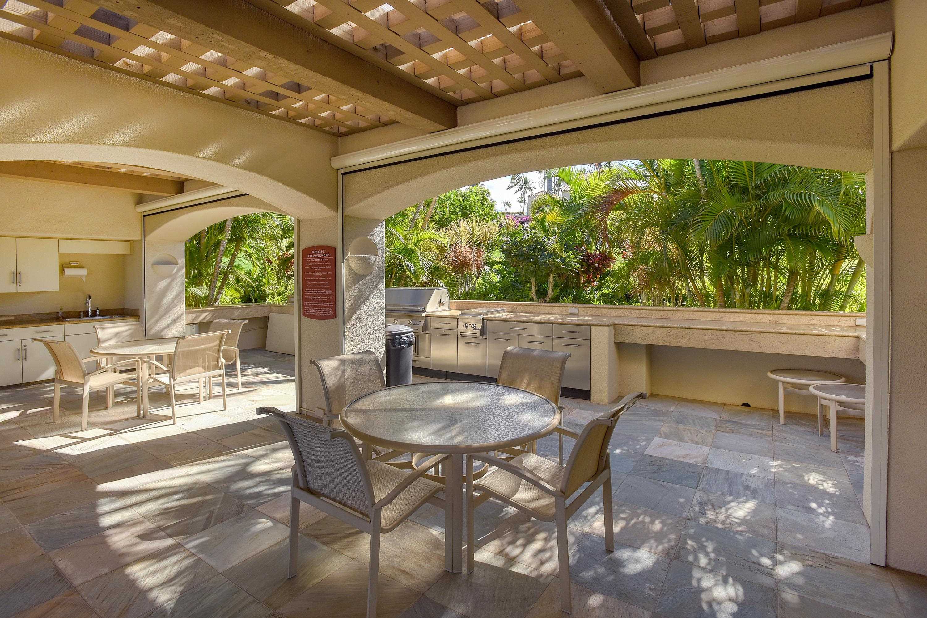 3150 Wailea Alanui Drive, Unit 3807 Kihei, HI 96753 - Photo 30 of 34 a dining room with furniture and a large window