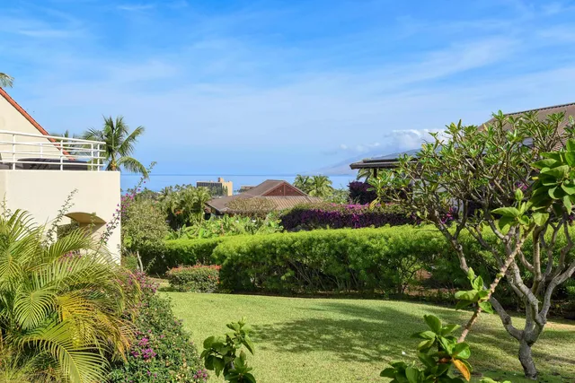 a view of a garden with a building in the background