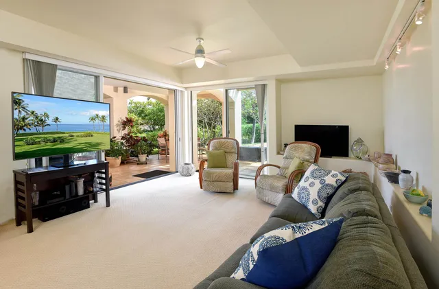a living room with furniture tv and a large window