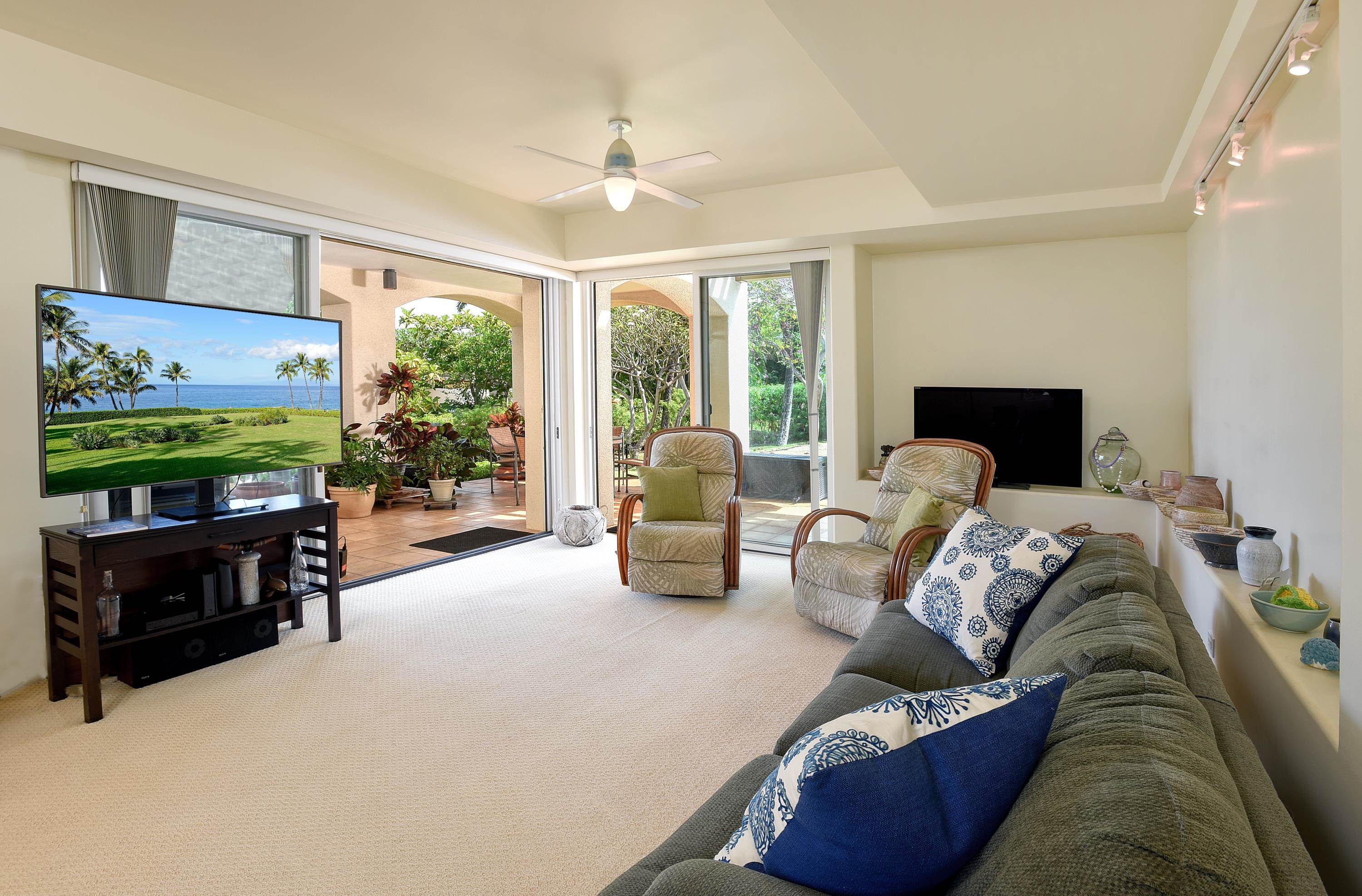 3150 Wailea Alanui Drive, Unit 3807 Kihei, HI 96753 - Photo 5 of 34 a living room with furniture tv and a large window