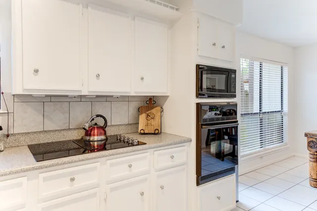a kitchen with stainless steel appliances a sink and cabinets