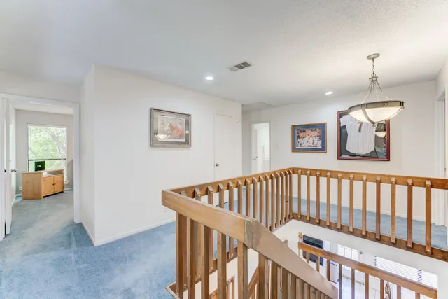 a view of hallway with stairs and a couch