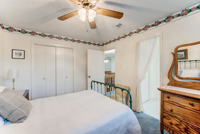 a bedroom with a bed a chandelier and a chandelier