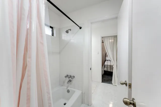 a bathroom with a shower and a tub