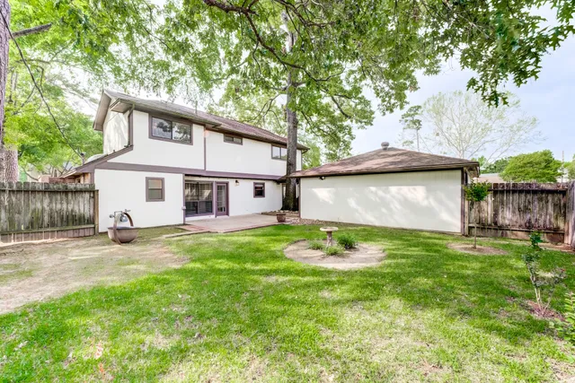 a view of a yard with a house and a tree