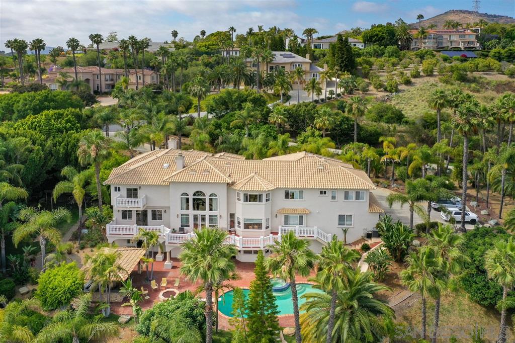 an aerial view of a house with yard and outdoor seating