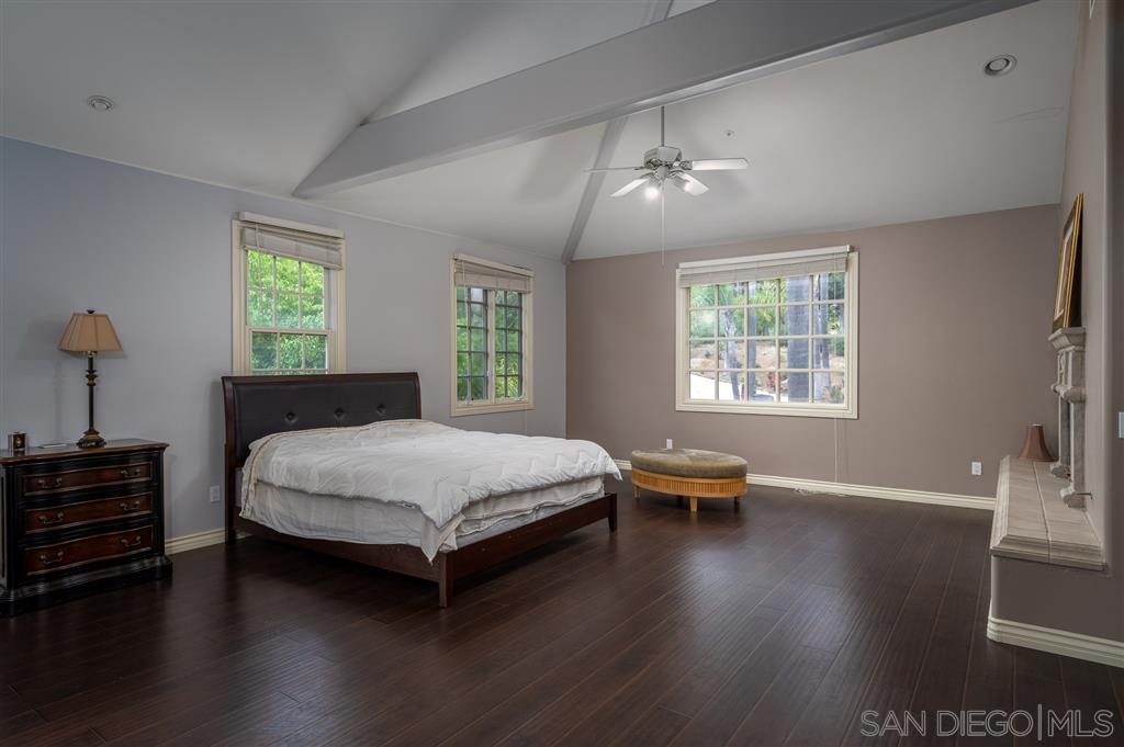 7302 Vista Rancho Court Rancho Santa Fe, CA 92091 - Photo 11 of 22 a bedroom with a bed and a chair