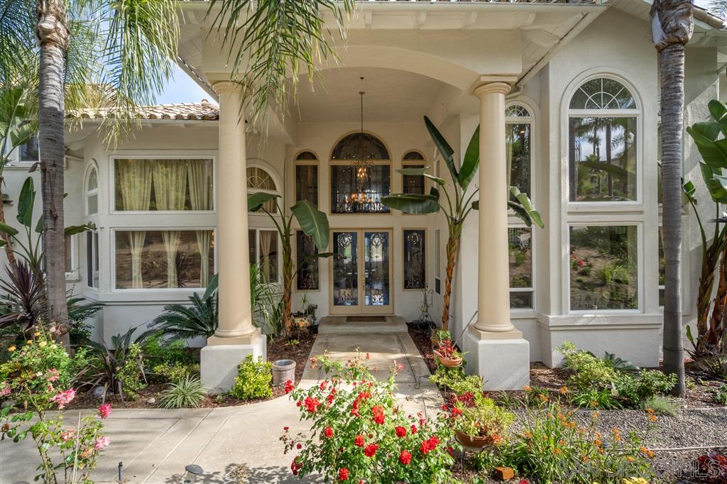 7302 Vista Rancho Court Rancho Santa Fe, CA 92091 - Photo 2 of 22 a front view of a house with a garden