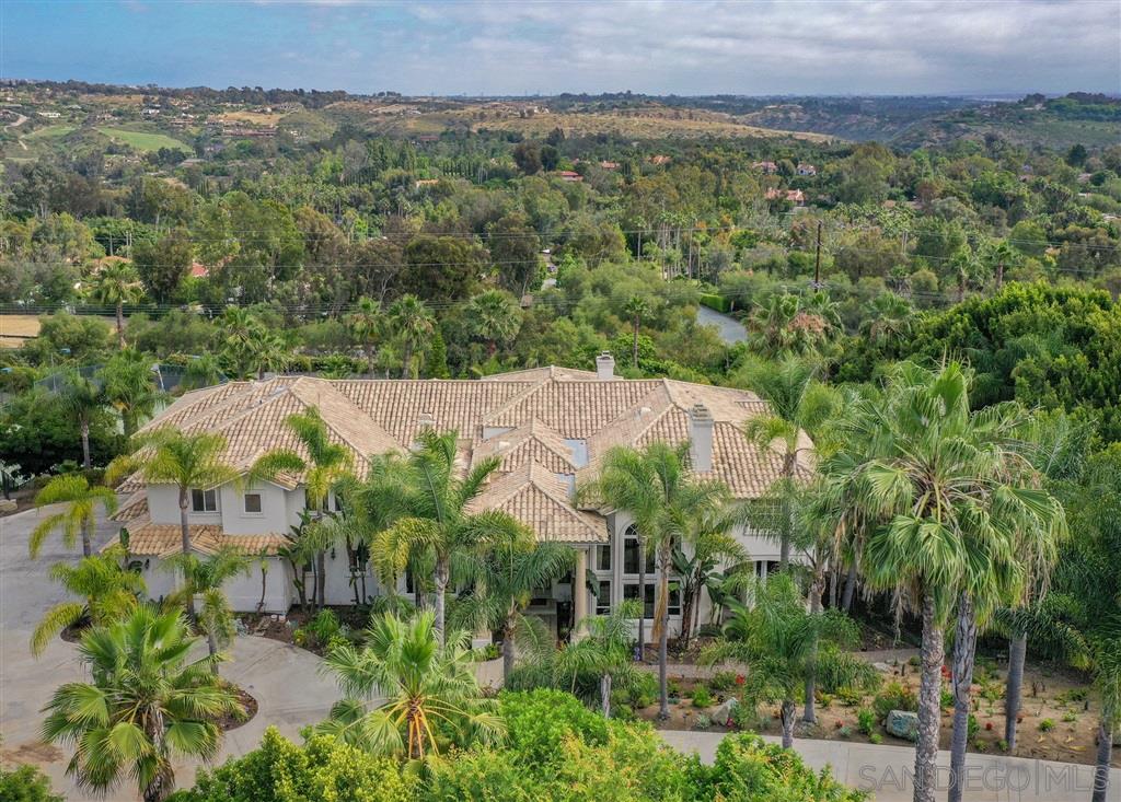 7302 Vista Rancho Court Rancho Santa Fe, CA 92091 - Photo 3 of 22 an aerial view of a houses with a lush green hillside