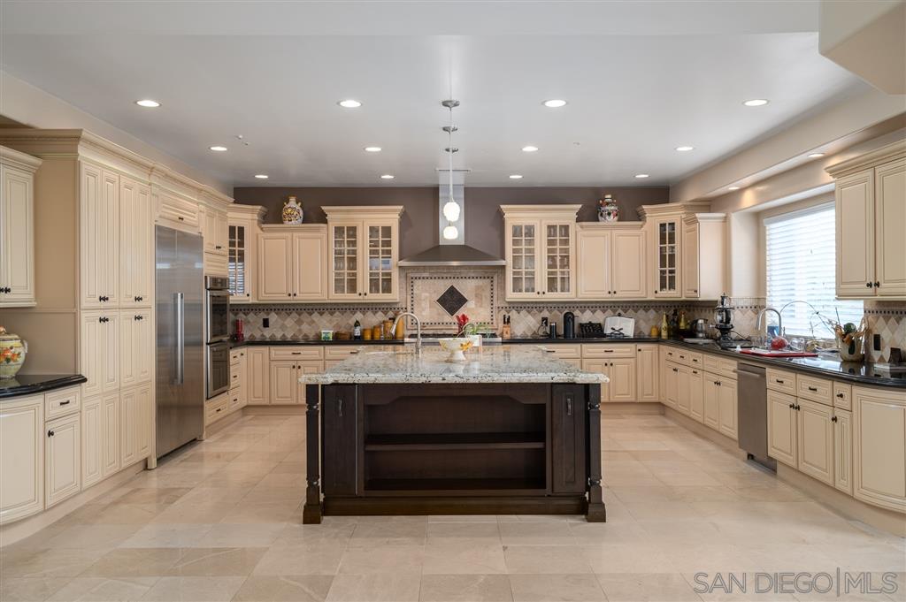 7302 Vista Rancho Court Rancho Santa Fe, CA 92091 - Photo 7 of 22 a large white kitchen with stainless steel appliances granite countertop a stove and a sink